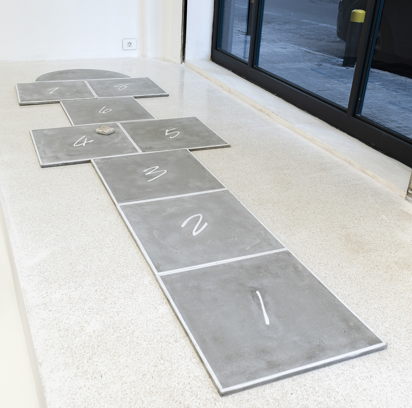 Hopscotch, 2024, 9 grout elements, oil pastel, Overall dimension: 337,3 × 100 × 2 cm, 8 elements of 50 × 50 cm each, 1 semi-circle 75,2 × 37,3 cm