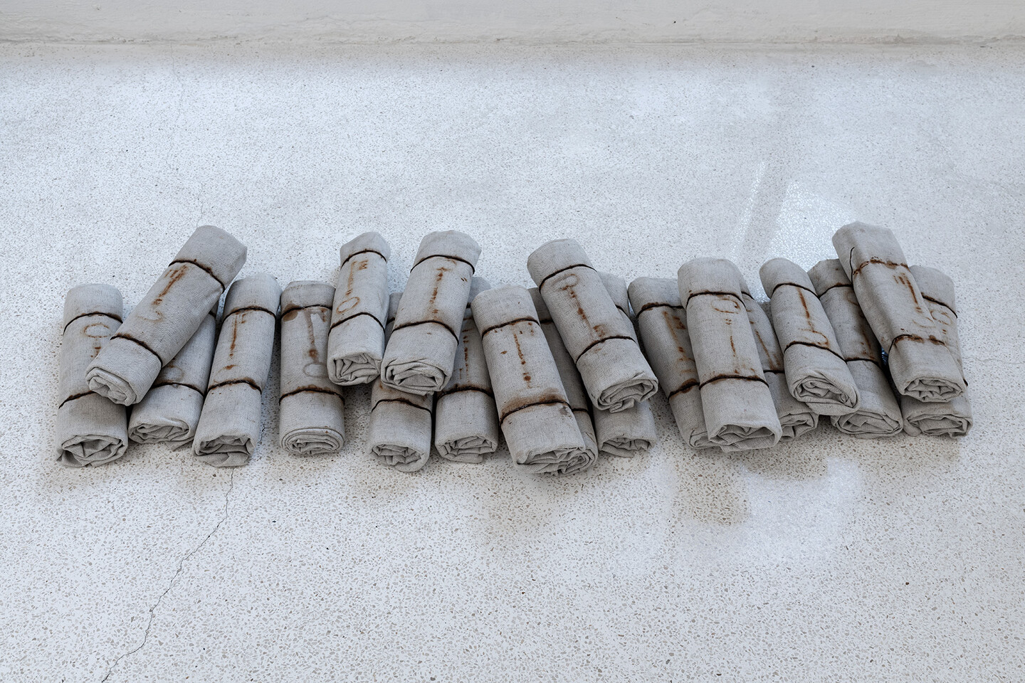 Untitled, 1997, Marks of rusty keys on rolled canvases, 20 elements