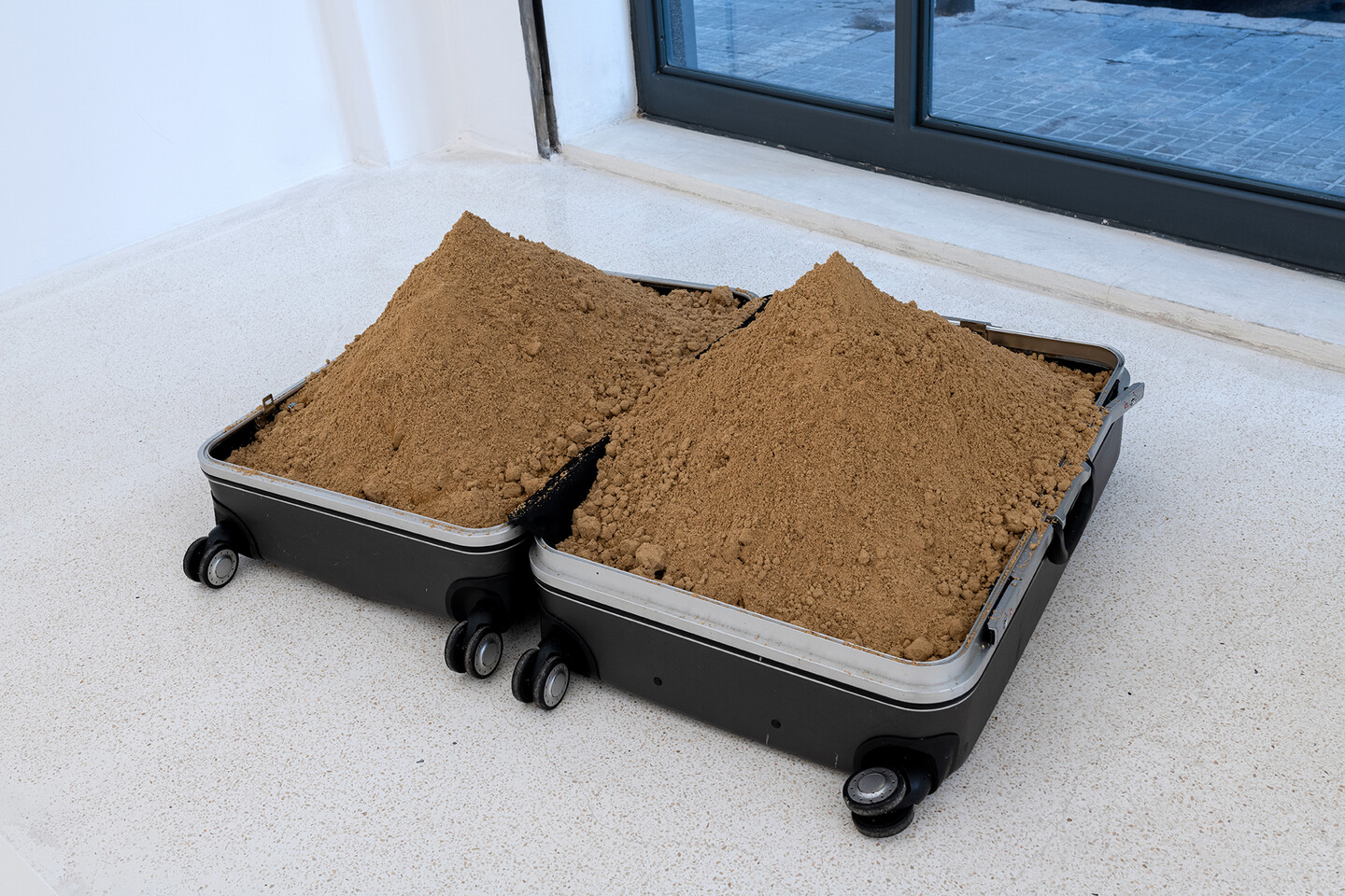 Untitled, 1998-2021, suitcase and sand, dimensions variable, 5 + 2 A.P., Courtesy the artist and Sfeir-Semler Gallery
