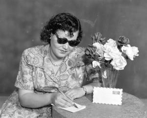 Hashem El Madani: Studio Practices, Palestinian girl writing a letter to her lover, Studio Shehrazade, 1950s, silver print, 24.5 x 19 cm